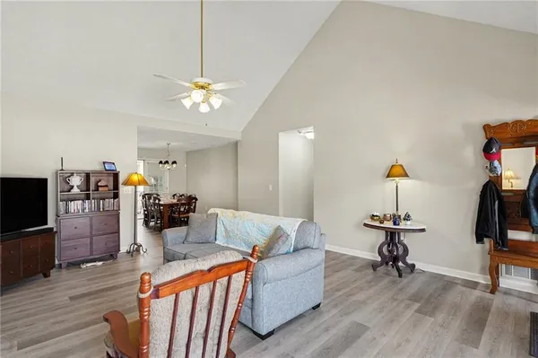 a living room with furniture a flat screen tv and a dresser