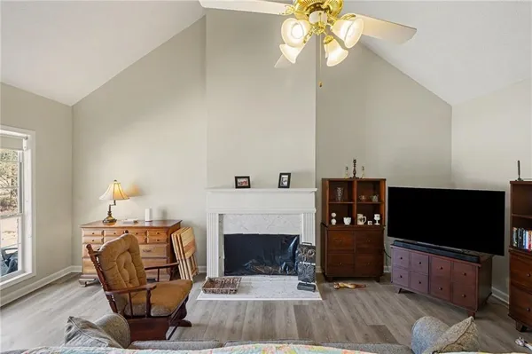 a living room with furniture a fireplace and a flat screen tv