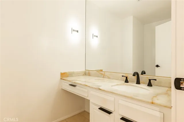 a kitchen with granite countertop a sink stove and cabinets