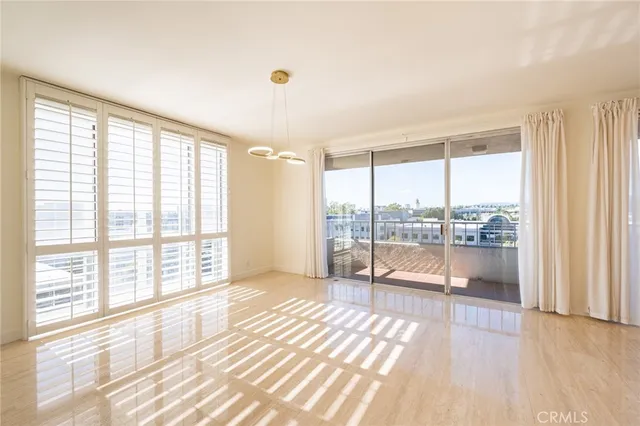 a living room with a large window and a wooden floor