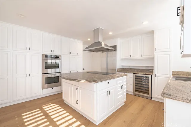 a kitchen with stainless steel appliances granite countertop a sink a stove and a refrigerator