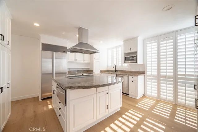 a kitchen with granite countertop a sink stove and cabinets