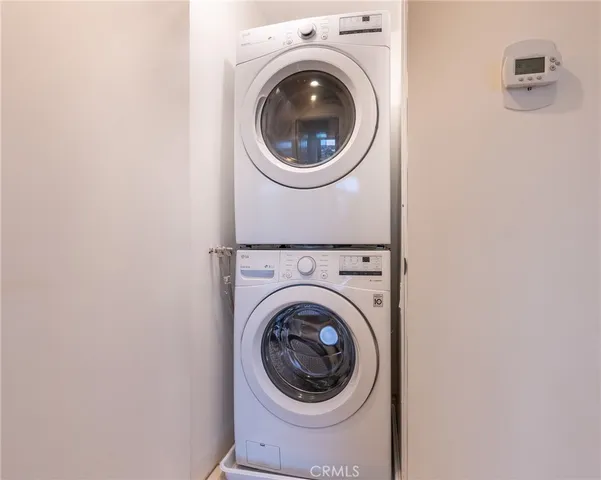 a view of an empty room with wooden floor and a floor to ceiling window