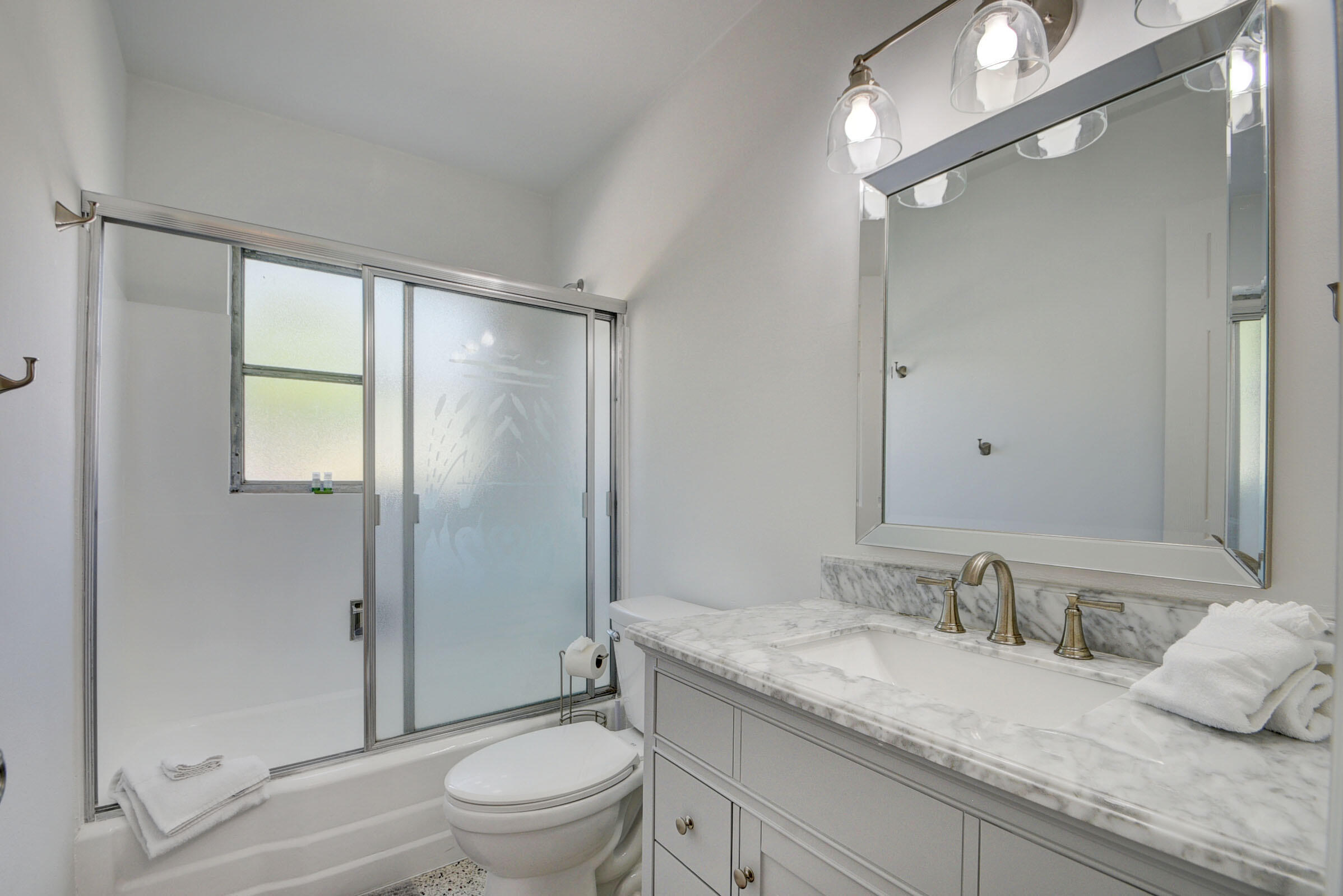 1171 Bimini Lane Singer Island, FL 33404 - Photo 13 of 61 a bathroom with a granite countertop sink toilet and shower