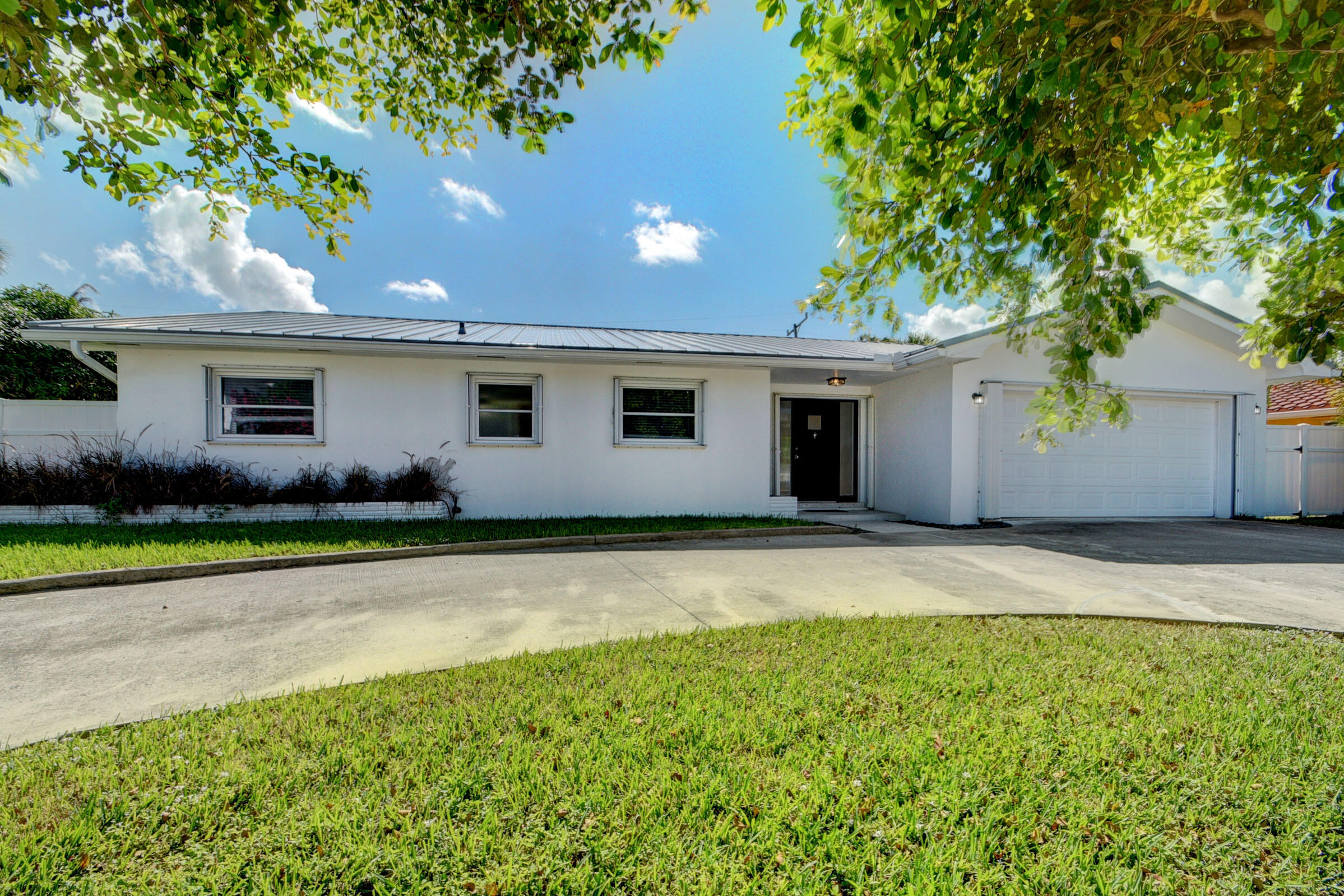1171 Bimini Lane Singer Island, FL 33404 - Photo 22 of 61 a front view of a house with garden