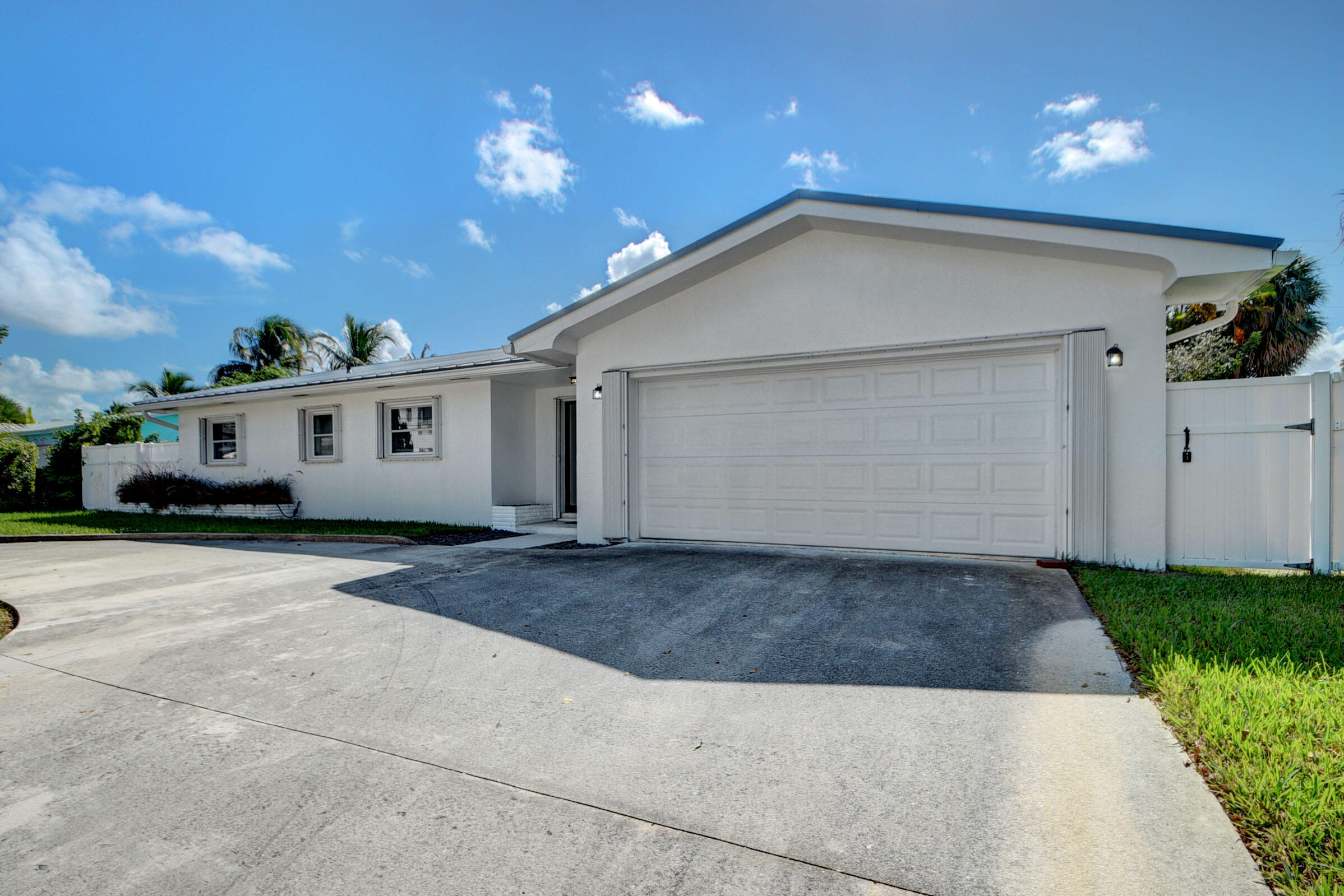 1171 Bimini Lane Singer Island, FL 33404 - Photo 37 of 61 a view of a house with a yard and garage