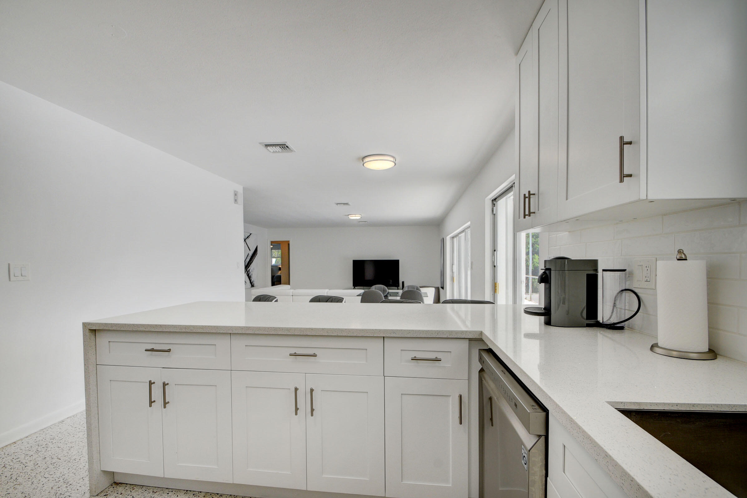1171 Bimini Lane Singer Island, FL 33404 - Photo 10 of 61 a kitchen with white cabinets and sink
