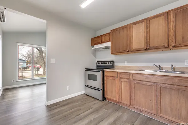 a kitchen with granite countertop white cabinets and white appliances