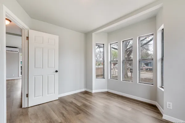 an empty room with windows and closet