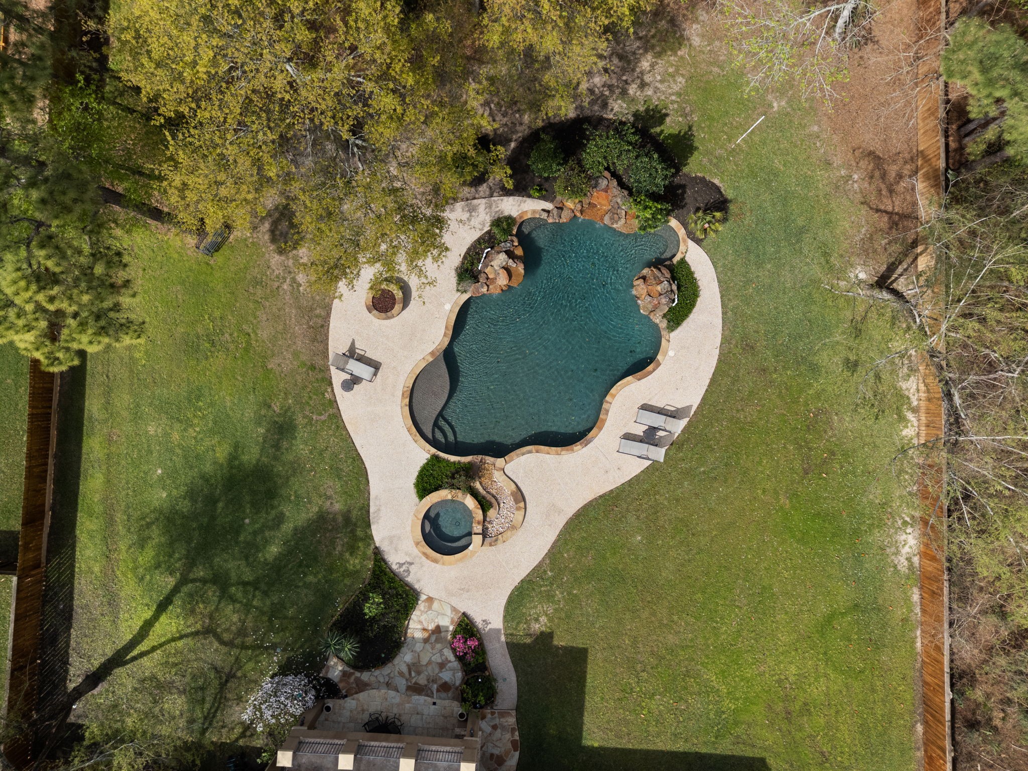 3907 Rayford Road Spring, TX 77386 - Photo 35 of 38 Overhead view of the backyard highlights the resort-style pool and spa, expansive green space, and peaceful, tree-lined surroundings.