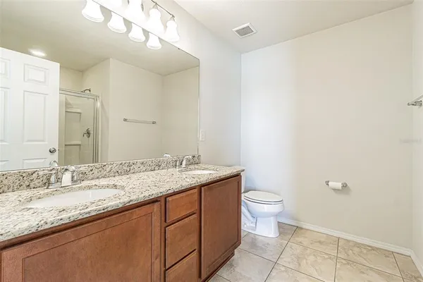 a bathroom with a glass shower door