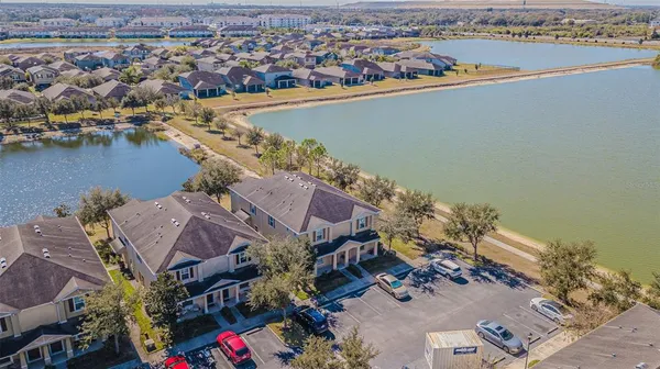 a aerial view of a house with a yard and lake view