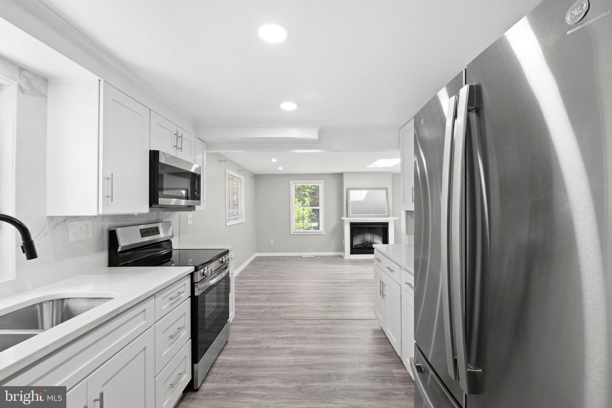 8405 Shirley Road Spotsylvania, VA 22551 - Photo 18 of 42 a kitchen with stainless steel appliances granite countertop a refrigerator and a sink