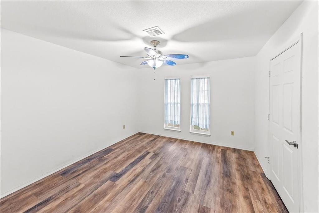 1812 Trinity Drive Waco, TX 76710 - Photo 15 of 24 wooden floor in an empty room with a window