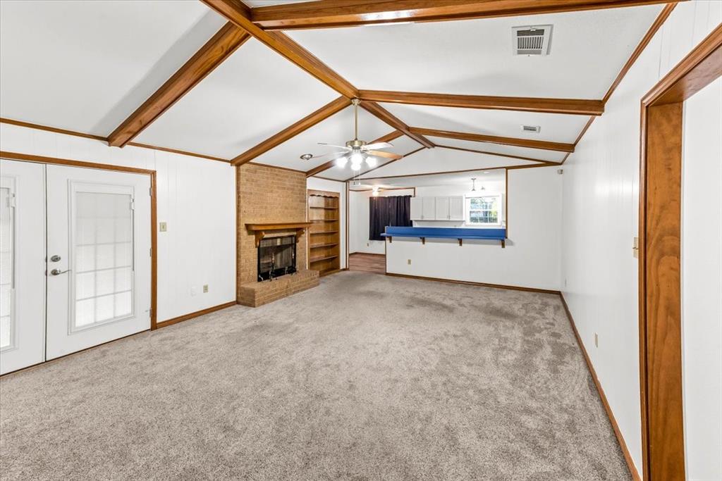 1812 Trinity Drive Waco, TX 76710 - Photo 2 of 24 a view of a hallway with an empty room and a window