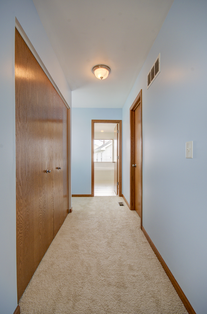 6417 Roth Drive Joliet, IL 60431 - Photo 28 of 32 a view of a hallway with an empty room and window