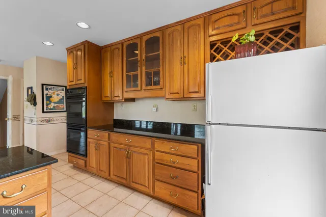 a kitchen with stainless steel appliances granite countertop a refrigerator and a stove