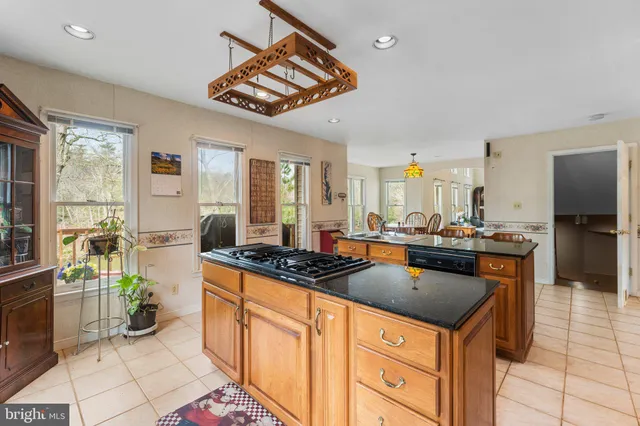 a kitchen with stainless steel appliances granite countertop a stove and a sink