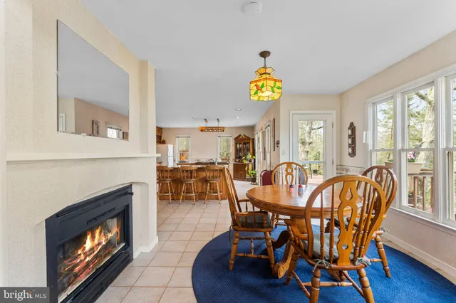 a dining room with furniture fireplace and wooden floor