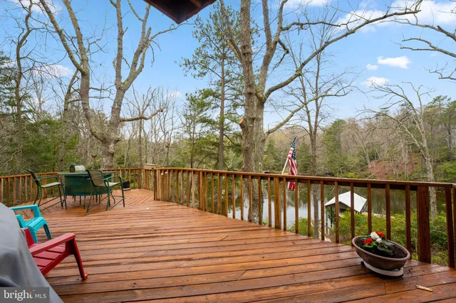 a bedroom with a large bed a chandelier and windows