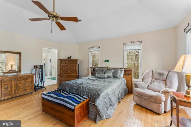 a spacious bathroom with a double vanity sink a large mirror and a shower
