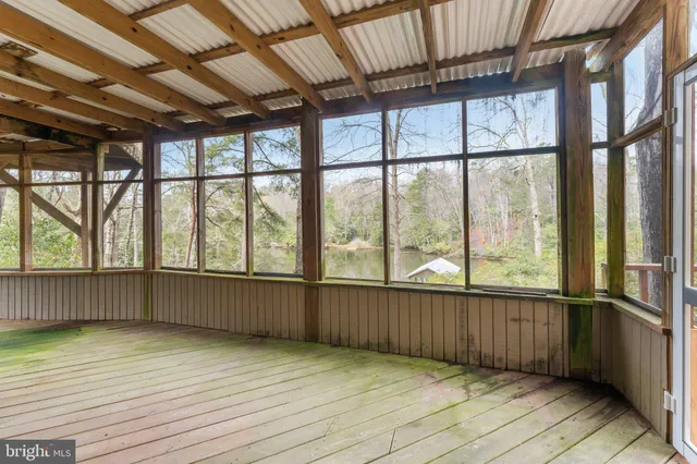 a view of balcony with wooden floor and fence