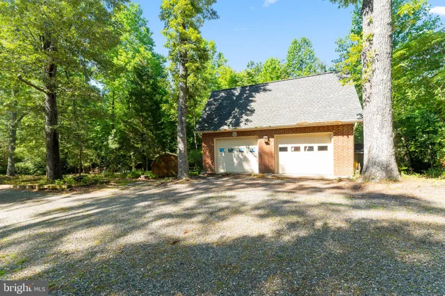 a view of a swimming pool with a patio and a yard