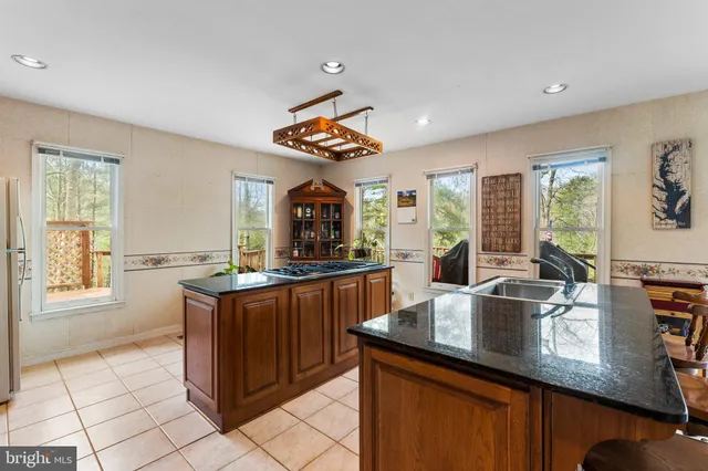 a kitchen with counter top space appliances and windows