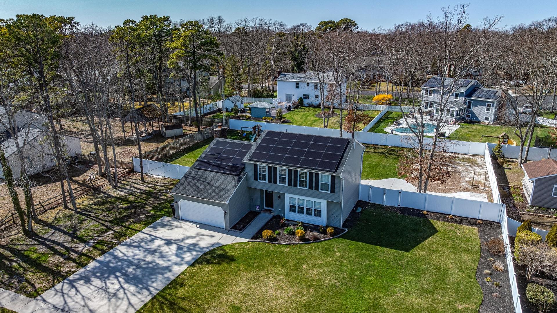 656 Stagecoach Road Marmora, NJ 08223 - Photo 4 of 45 a view of a house with backyard outdoor seating and trees in the background