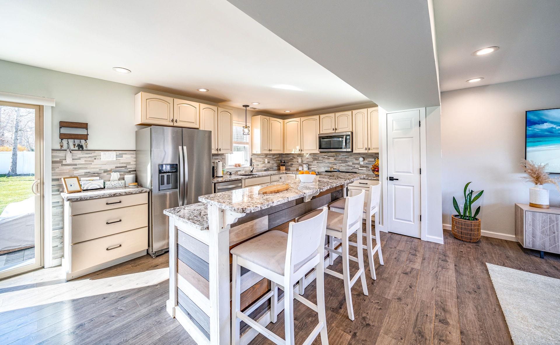 656 Stagecoach Road Marmora, NJ 08223 - Photo 7 of 45 a kitchen with stainless steel appliances kitchen island granite countertop a refrigerator and a stove top oven