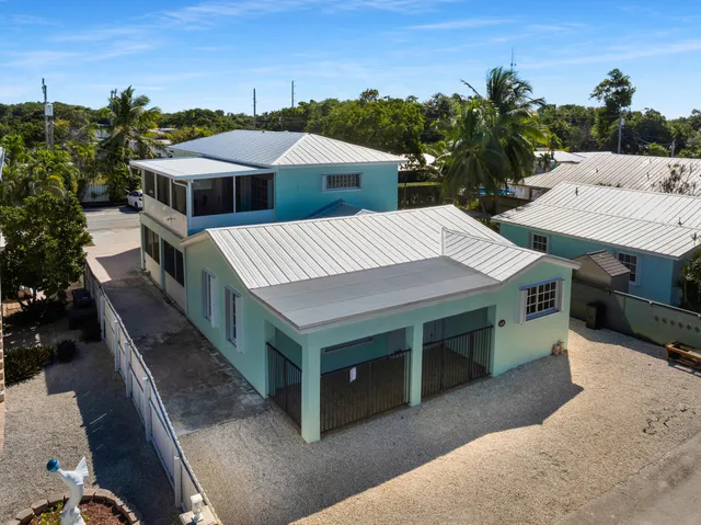 a view of a house with roof deck front of house