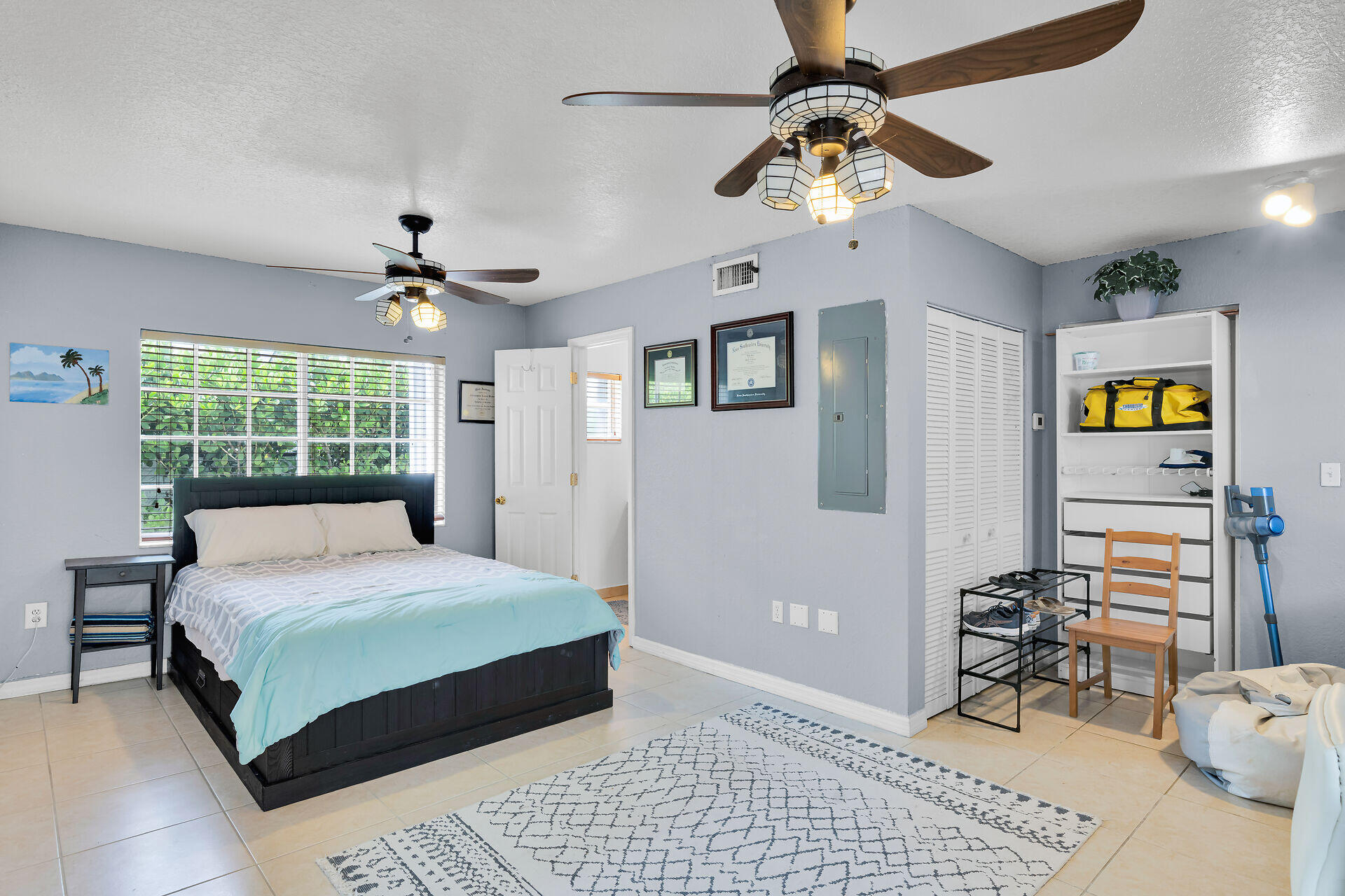 64 Coconut Drive Key Largo, FL 33037 - Photo 17 of 44 a bedroom with a bed and a chandelier