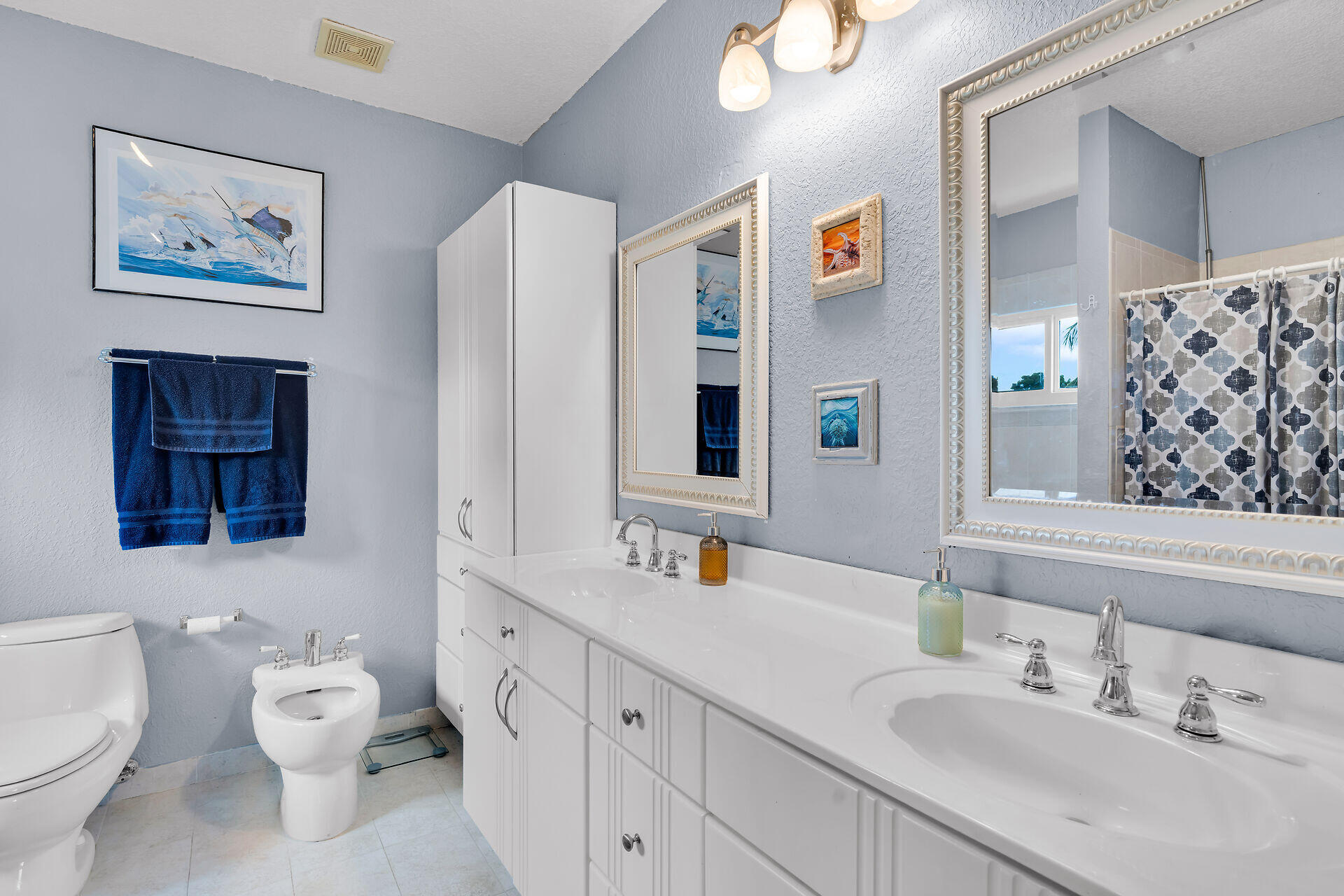 64 Coconut Drive Key Largo, FL 33037 - Photo 19 of 44 a bathroom with a toilet sink and mirror