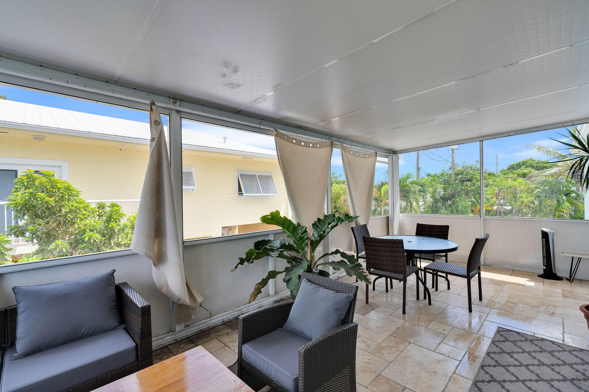 64 Coconut Drive Key Largo, FL 33037 - Photo 22 of 44 a dining room with furniture and a large window