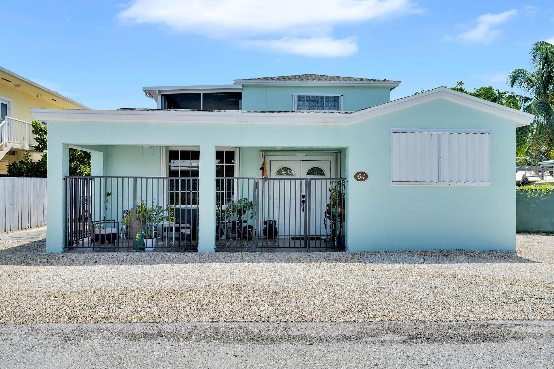 64 Coconut Drive Key Largo, FL 33037 - Photo 3 of 44 a front view of a house with garden