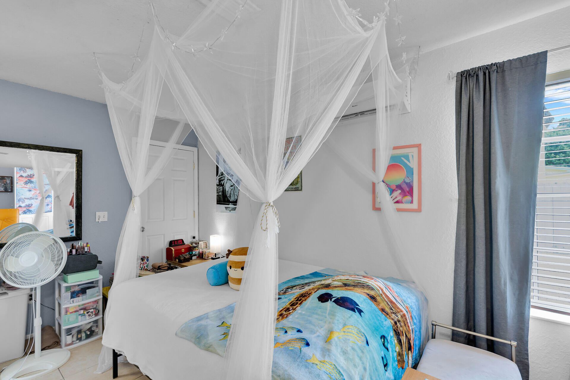 64 Coconut Drive Key Largo, FL 33037 - Photo 33 of 44 a bedroom with a bed and a dining table with painted walls