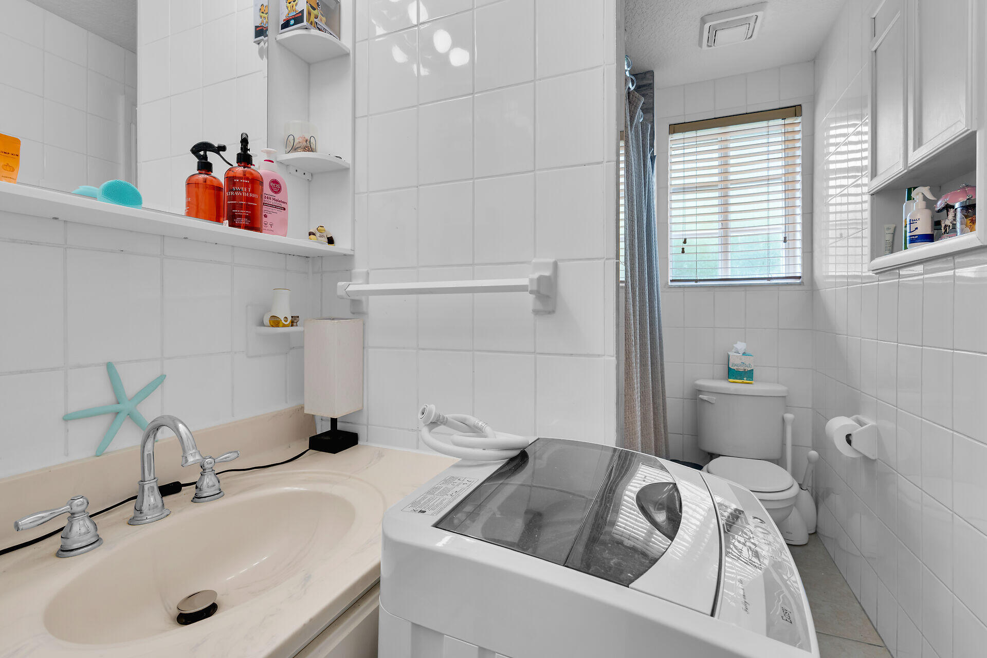 64 Coconut Drive Key Largo, FL 33037 - Photo 36 of 44 a bathroom with a sink and a large mirror