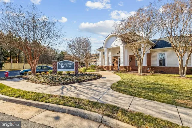 a view of a white house with a yard