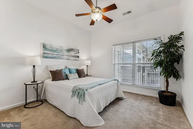 a bedroom with a bed and a large window