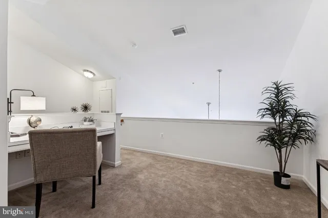 a view of kitchen with furniture and a potted plant