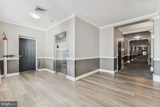 a view of empty room with wooden floor
