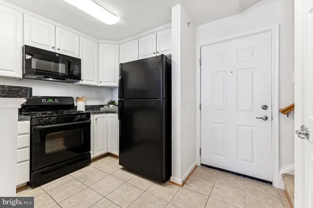 a kitchen with a refrigerator stove and microwave
