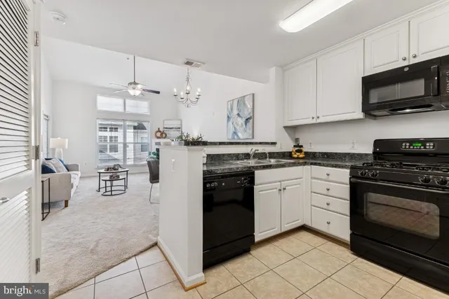 a kitchen with stainless steel appliances granite countertop a stove and cabinets
