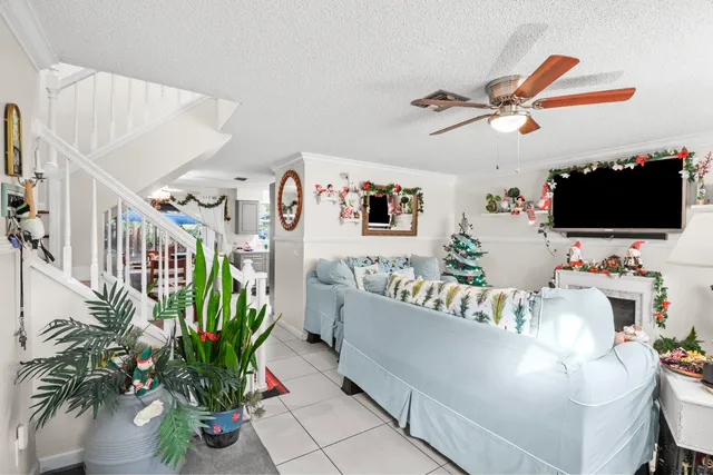 a living room with furniture and a potted plant