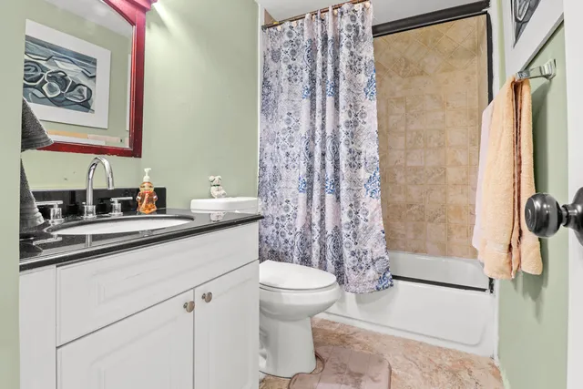 a bedroom with bed and a chandelier