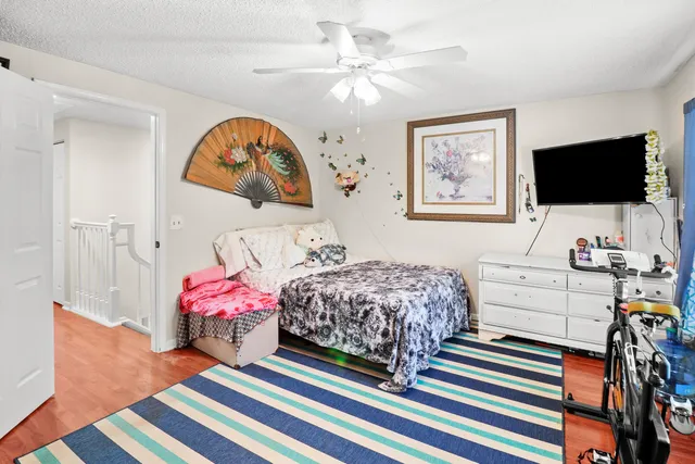 a bedroom with a bed and a dresser in it