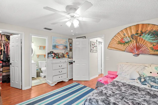 a white toilet sitting next to a bathroom sink and a mirror