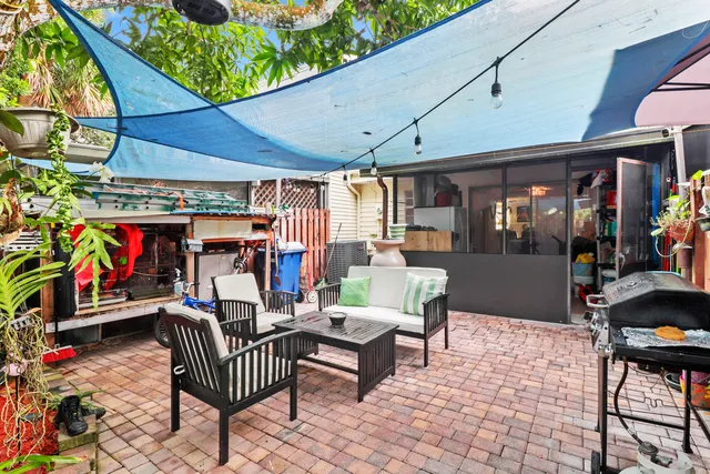 a view of a patio with a table and chairs