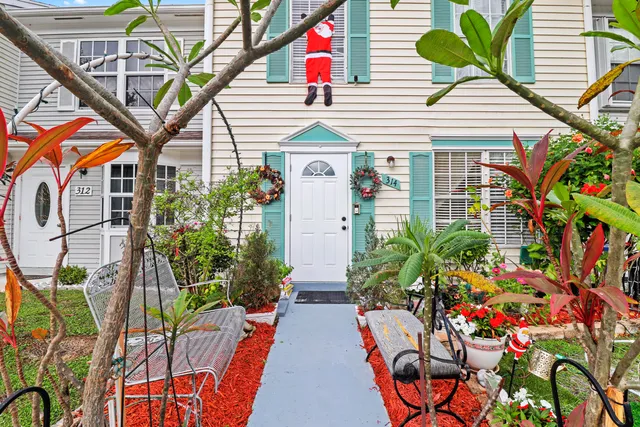 a view of a house with a backyard and a tree