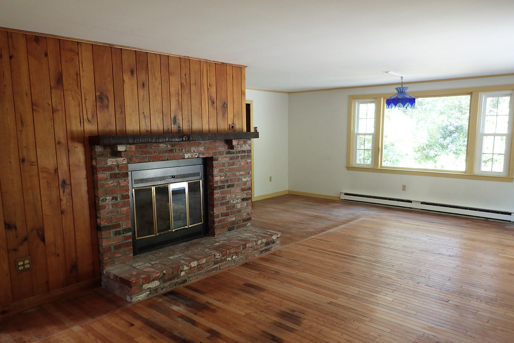 5 Blackfish Road Truro, MA 02666 - Photo 3 of 21 an empty room with wooden floor windows and fireplace